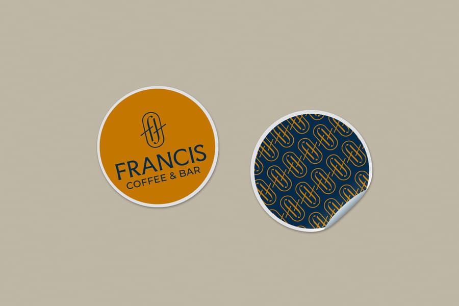 Stickers circulares de Francis: uno dorado con el imagotipo y otro azul con el patrón